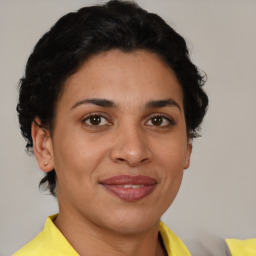 Joyful latino young-adult female with short  brown hair and brown eyes