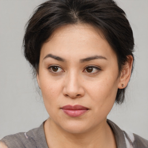 Joyful asian young-adult female with medium  brown hair and brown eyes