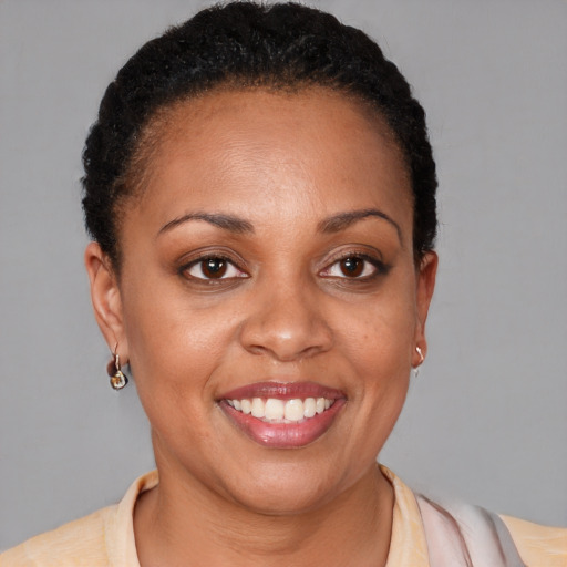 Joyful black adult female with short  brown hair and brown eyes