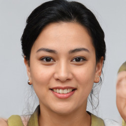 Joyful asian young-adult female with medium  brown hair and brown eyes