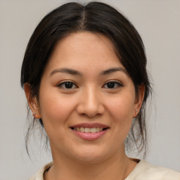 Joyful asian young-adult female with medium  brown hair and brown eyes