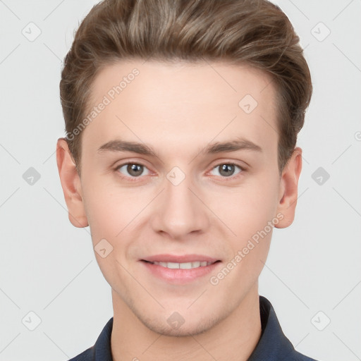 Joyful white young-adult male with short  brown hair and grey eyes