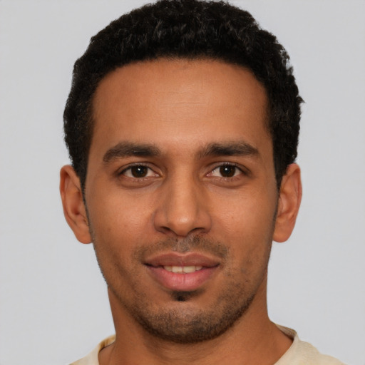 Joyful latino young-adult male with short  black hair and brown eyes