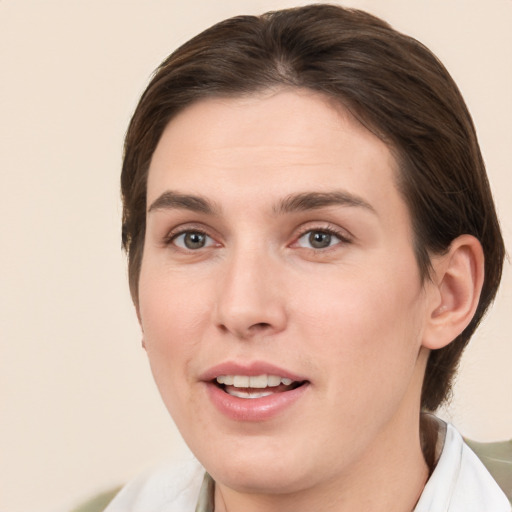 Joyful white young-adult female with short  brown hair and brown eyes