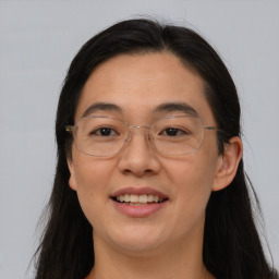 Joyful white adult female with long  brown hair and brown eyes