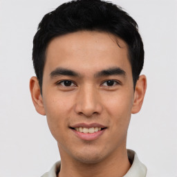 Joyful asian young-adult male with short  black hair and brown eyes