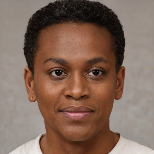 Joyful black young-adult female with short  black hair and brown eyes