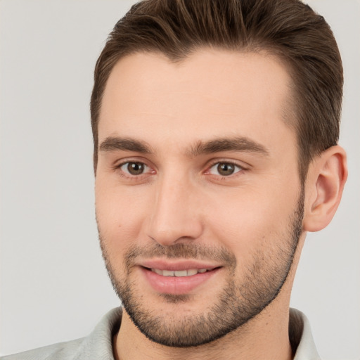 Joyful white young-adult male with short  brown hair and brown eyes