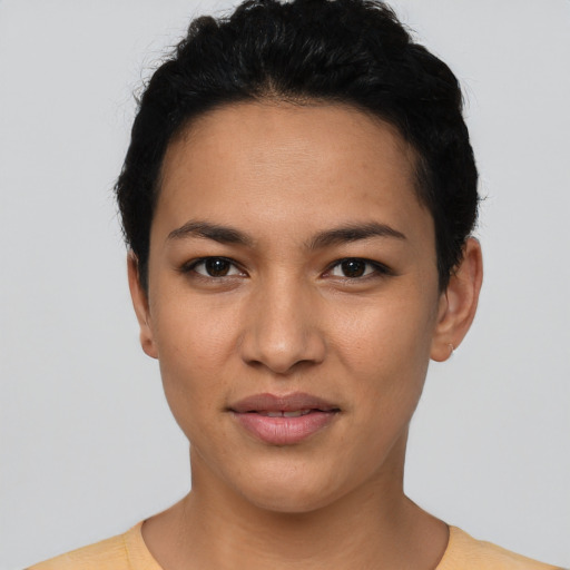 Joyful latino young-adult female with short  black hair and brown eyes