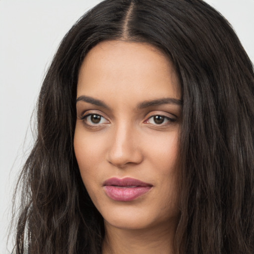 Joyful white young-adult female with long  black hair and brown eyes