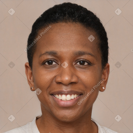 Joyful black young-adult female with short  black hair and brown eyes