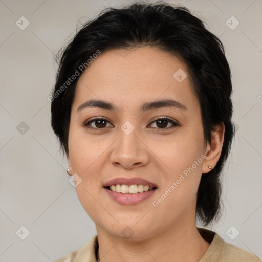 Joyful latino young-adult female with medium  brown hair and brown eyes