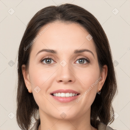 Joyful white young-adult female with medium  brown hair and grey eyes