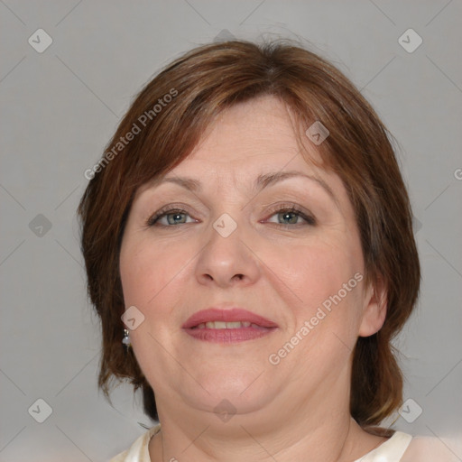 Joyful white adult female with medium  brown hair and blue eyes