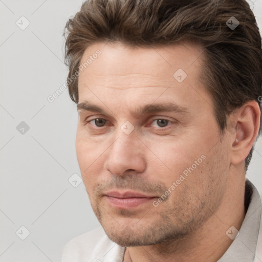 Joyful white adult male with short  brown hair and brown eyes