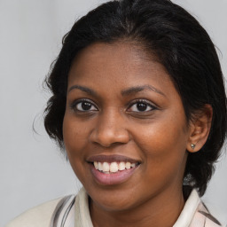 Joyful black young-adult female with medium  brown hair and brown eyes