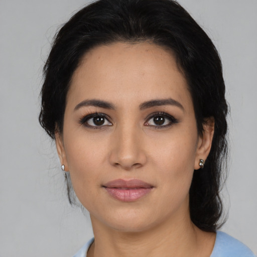 Joyful latino young-adult female with medium  black hair and brown eyes