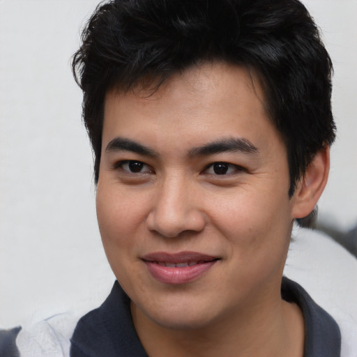 Joyful asian young-adult male with short  brown hair and brown eyes