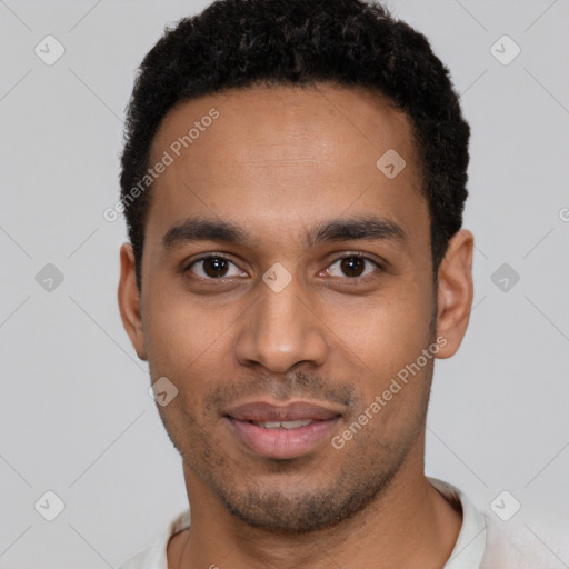 Joyful black young-adult male with short  brown hair and brown eyes