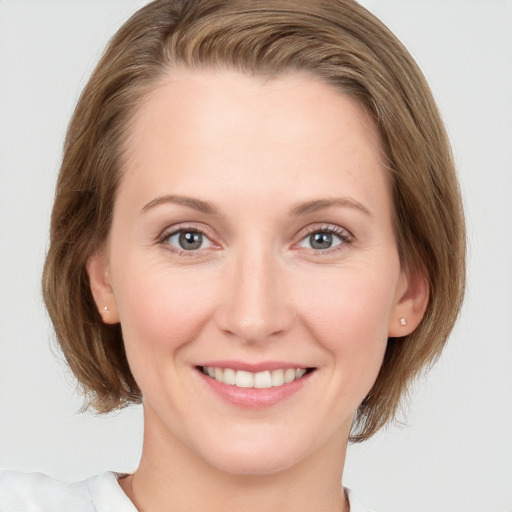 Joyful white young-adult female with medium  brown hair and blue eyes