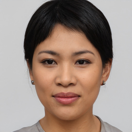 Joyful asian young-adult female with medium  black hair and brown eyes