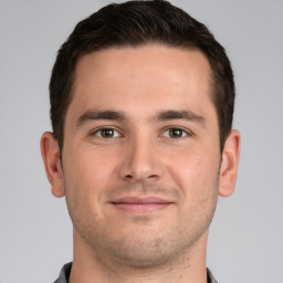 Joyful white young-adult male with short  brown hair and brown eyes