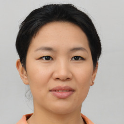 Joyful asian young-adult female with short  brown hair and brown eyes