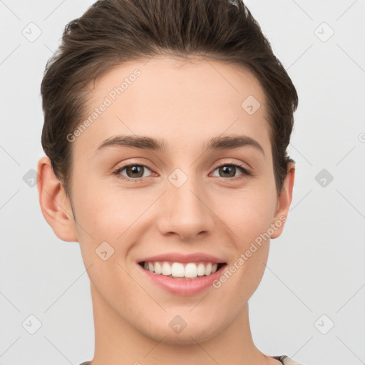 Joyful white young-adult female with short  brown hair and grey eyes