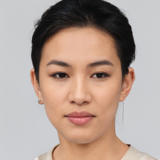 Joyful asian young-adult female with short  black hair and brown eyes