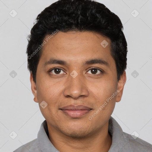 Joyful latino young-adult male with short  black hair and brown eyes