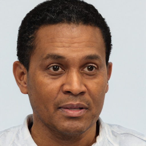 Joyful black adult male with short  brown hair and brown eyes