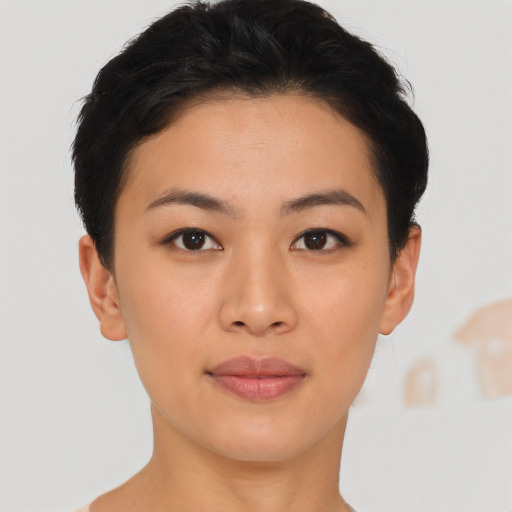 Joyful asian young-adult female with short  brown hair and brown eyes