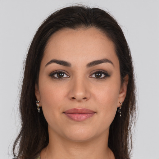 Joyful white young-adult female with long  brown hair and brown eyes