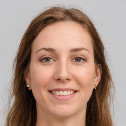 Joyful white young-adult female with long  brown hair and grey eyes