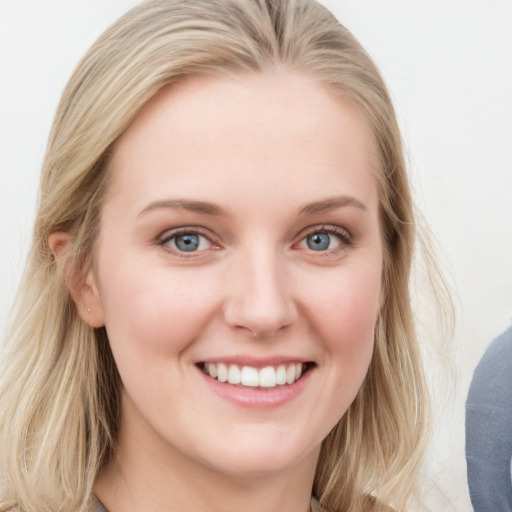 Joyful white young-adult female with long  brown hair and blue eyes