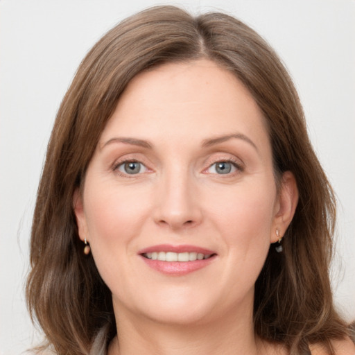 Joyful white young-adult female with long  brown hair and grey eyes