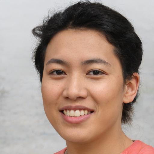 Joyful asian young-adult female with short  brown hair and brown eyes