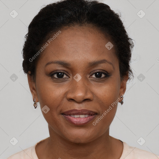 Joyful black adult female with short  brown hair and brown eyes