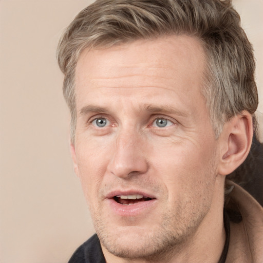 Joyful white adult male with short  brown hair and grey eyes