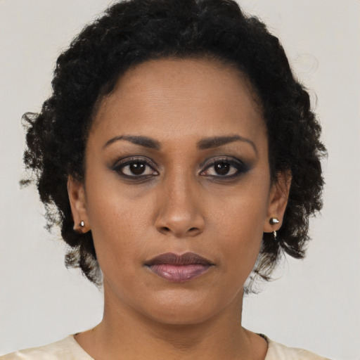 Neutral black young-adult female with long  brown hair and brown eyes