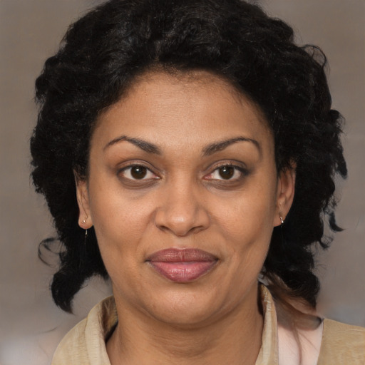 Joyful black adult female with medium  brown hair and brown eyes