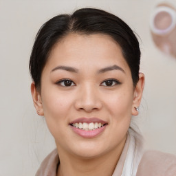 Joyful asian young-adult female with medium  brown hair and brown eyes