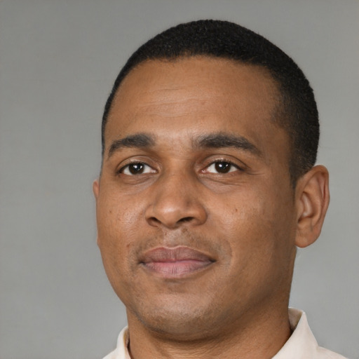 Joyful latino adult male with short  black hair and brown eyes