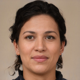 Joyful white adult female with medium  brown hair and brown eyes