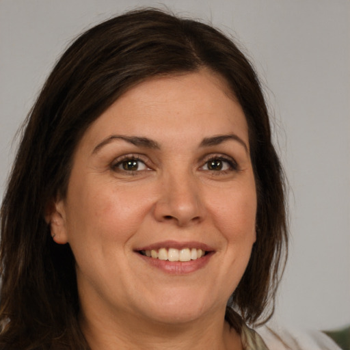 Joyful white adult female with medium  brown hair and brown eyes