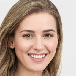 Joyful white young-adult female with long  brown hair and green eyes