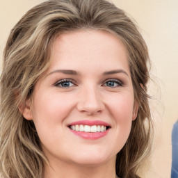 Joyful white young-adult female with medium  brown hair and green eyes