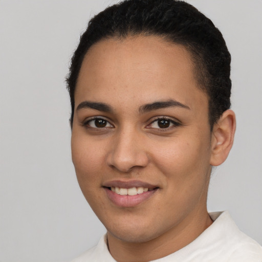 Joyful latino young-adult female with short  brown hair and brown eyes