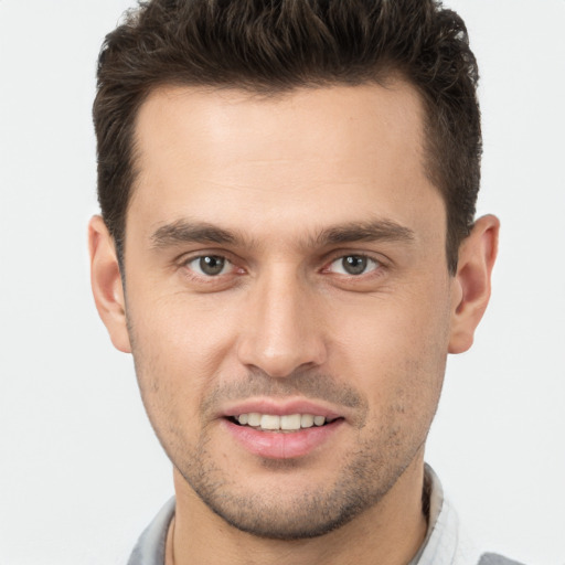 Joyful white young-adult male with short  brown hair and brown eyes