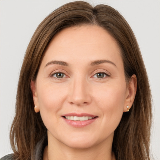 Joyful white young-adult female with long  brown hair and brown eyes